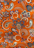 Orangish fabric with intricate paisley and floral patterns