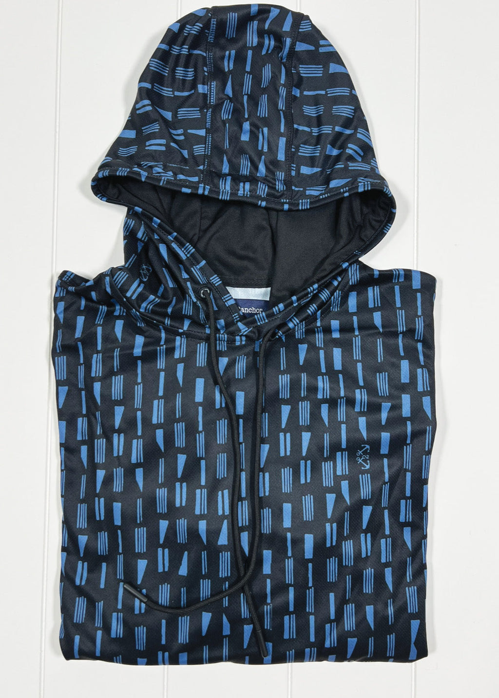 Black and blue patterned hooded poncho on a white background