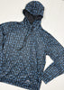 Blue and black patterned raincoat on a white background