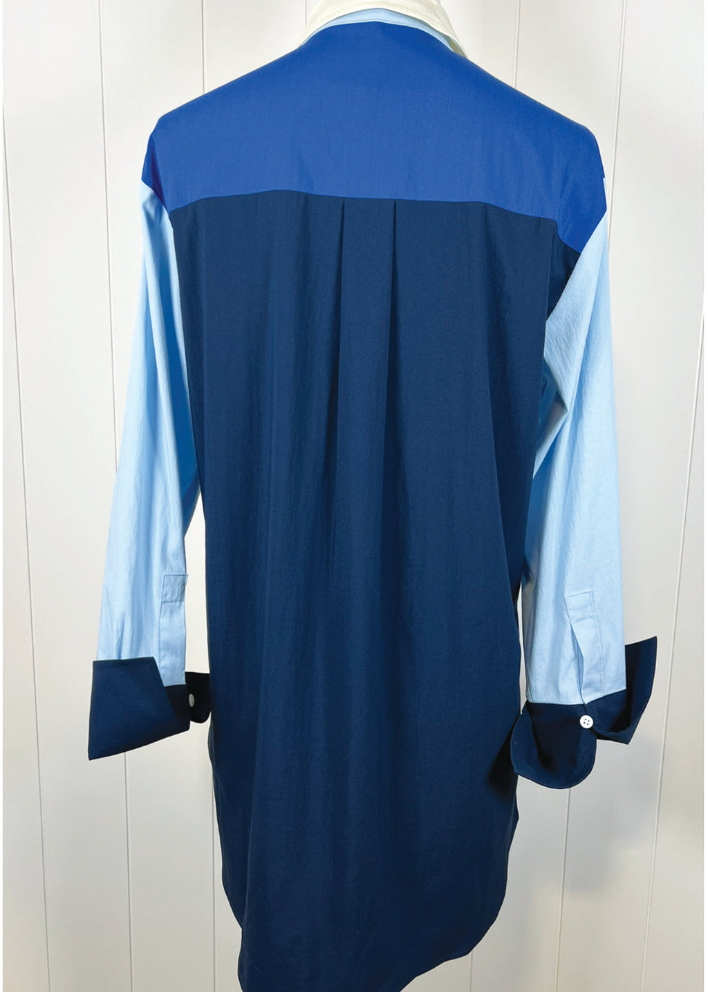 Navy blue and light blue dress on a white background