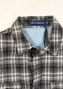 Plaid shirt with a visible brand label on a light background