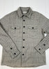 Plaid shirt with black buttons on a white wooden surface