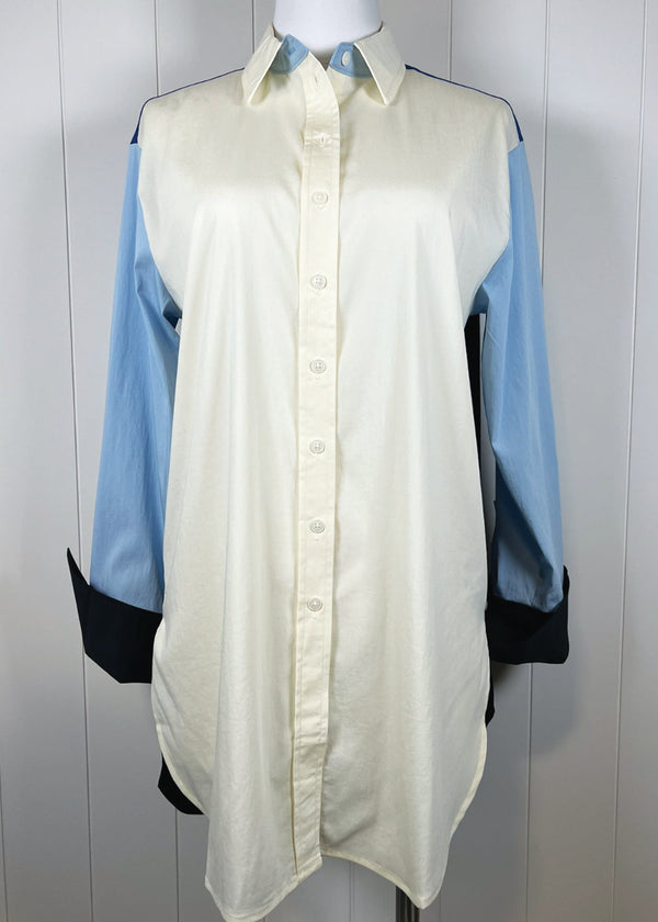 Light green shirt with blue sleeves on a mannequin against a white background