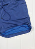Blue athletic shorts on a white background
