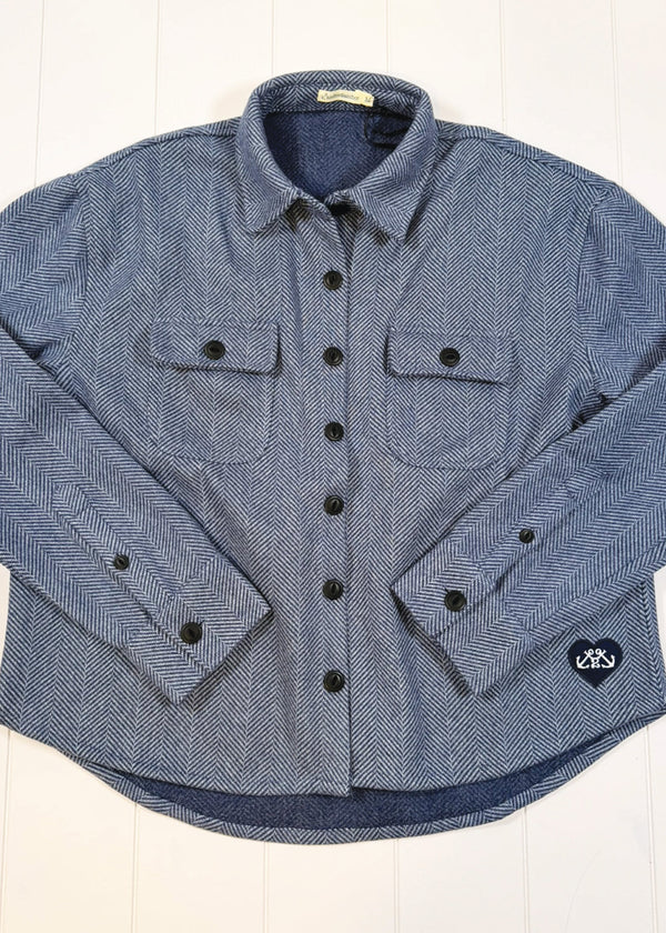 Blue flannel shirt with black buttons on a white background