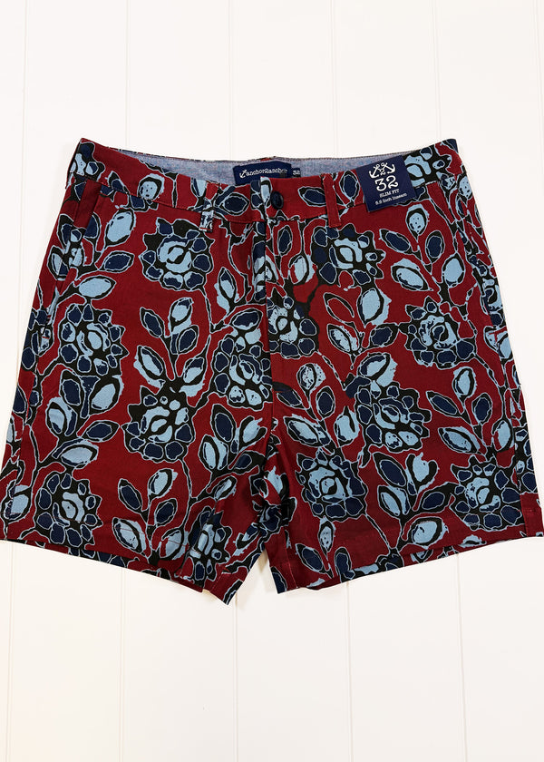 Red shorts with blue floral pattern on a white background