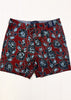 Red shorts with blue floral pattern on a white background