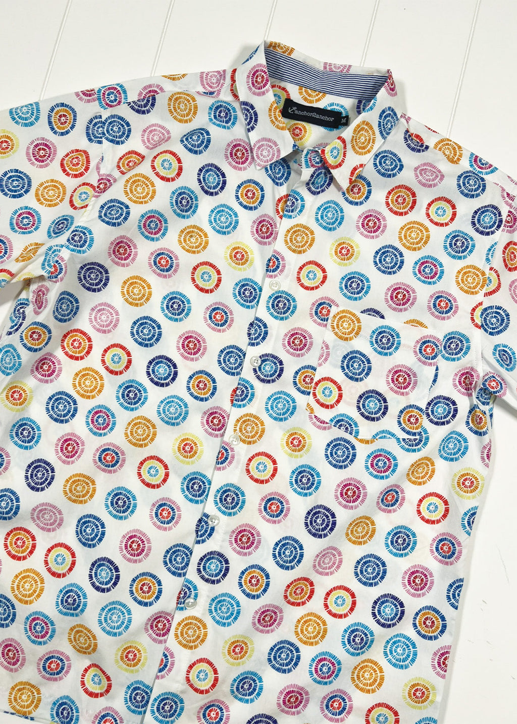 Colorful circular patterned shirt on a white background