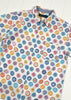 Colorful circular patterned shirt on a white background