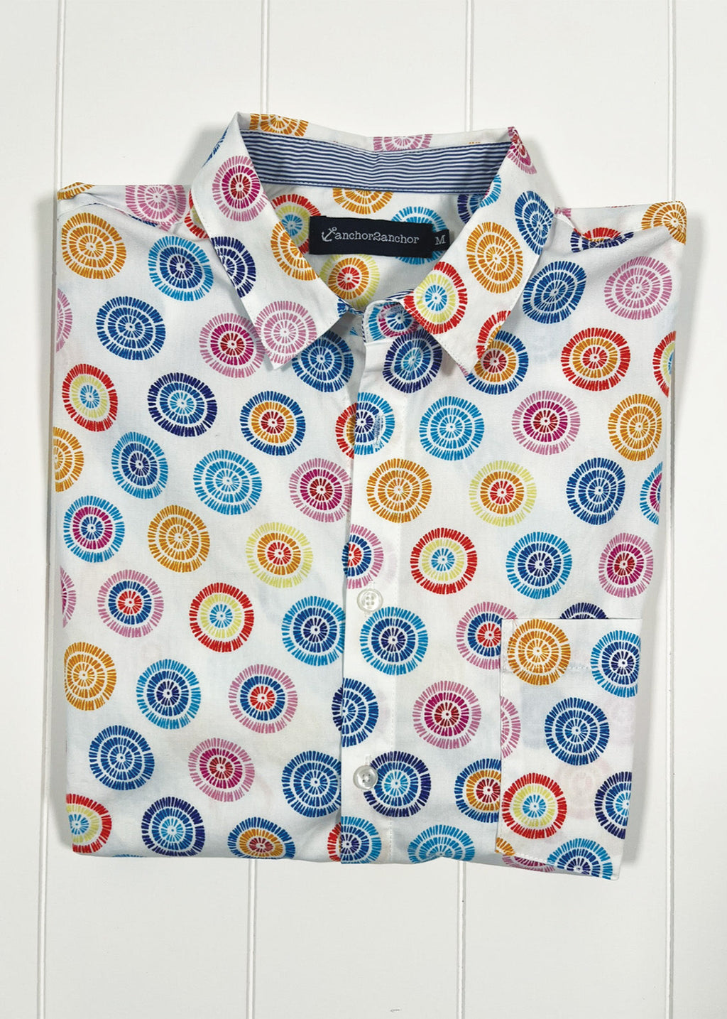 Colorful circular patterned shirt on a white background