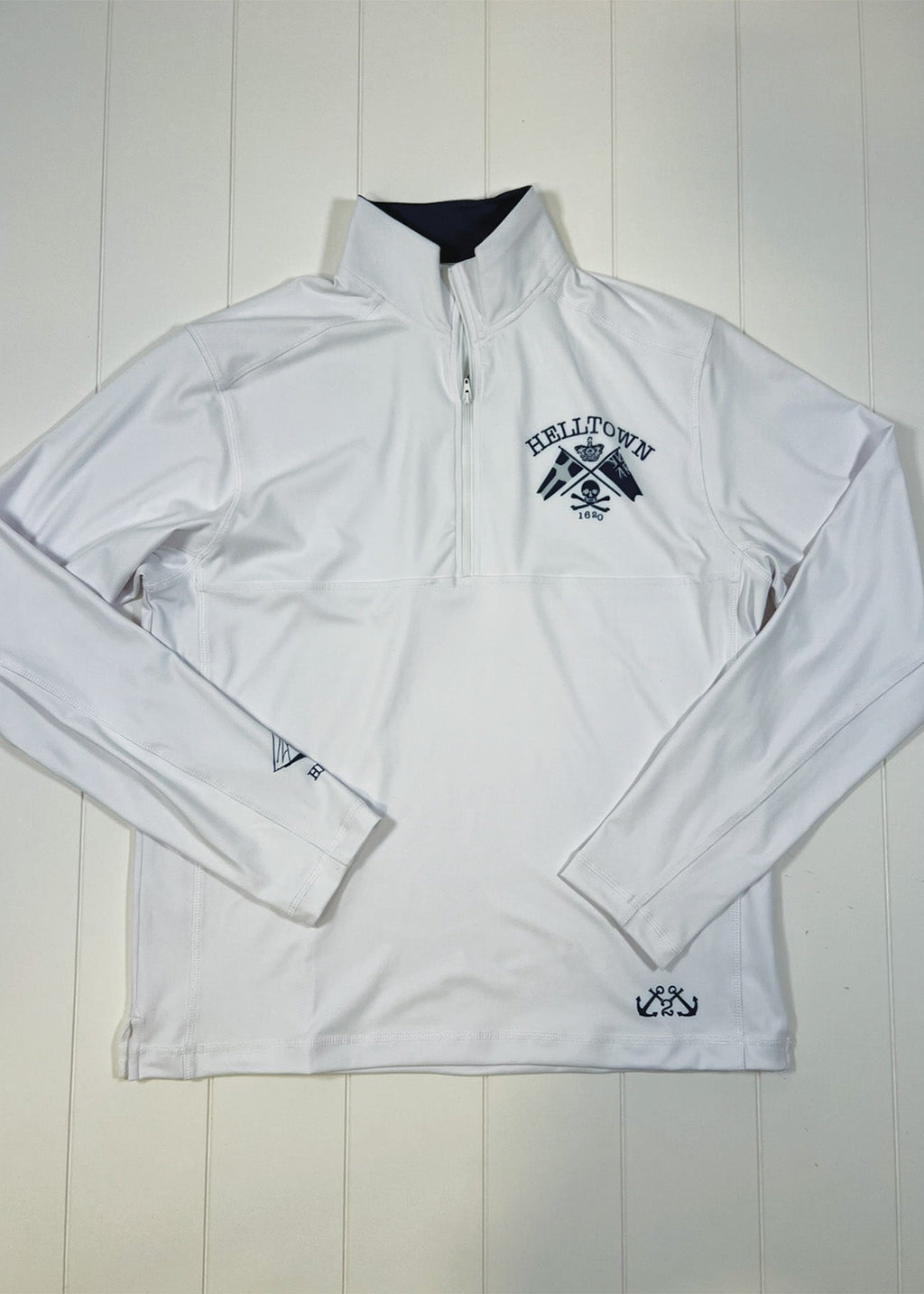 White jacket with black logo on a white wooden background