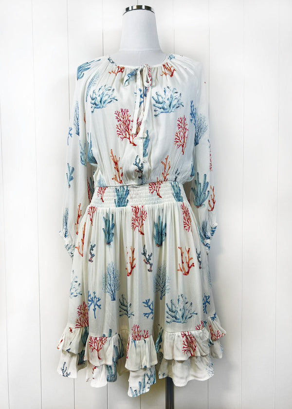 Dress with coral pattern on a mannequin against a white background