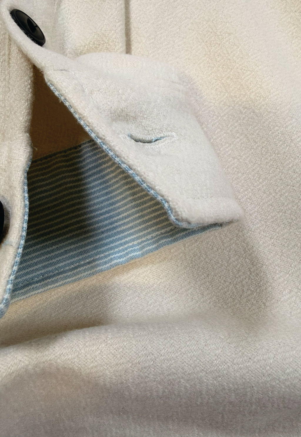Close-up of a light-colored fabric with a textured interior lining.
