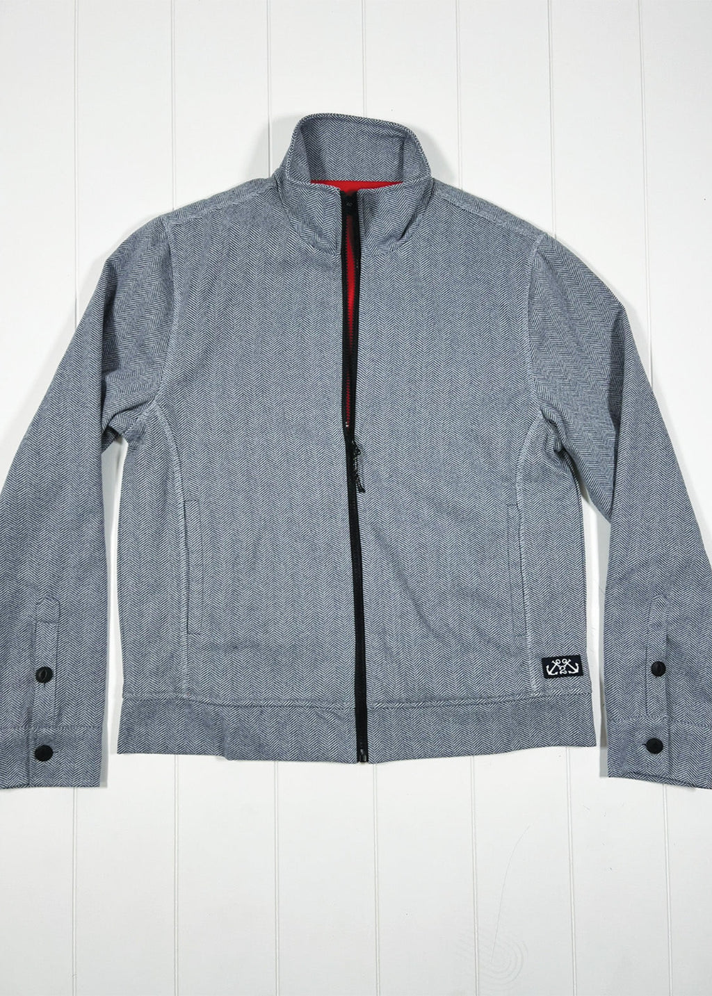 Gray jacket with black buttons on a white wooden background