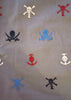 Pattern of embroidered skull and crossbones designs on a fabric background