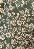 Close-up of green fabric with beige floral pattern
