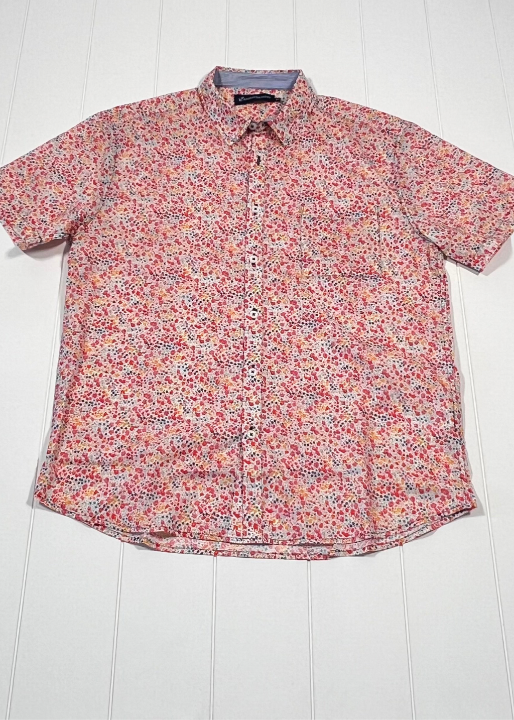 Floral patterned shirt on a white wooden surface
