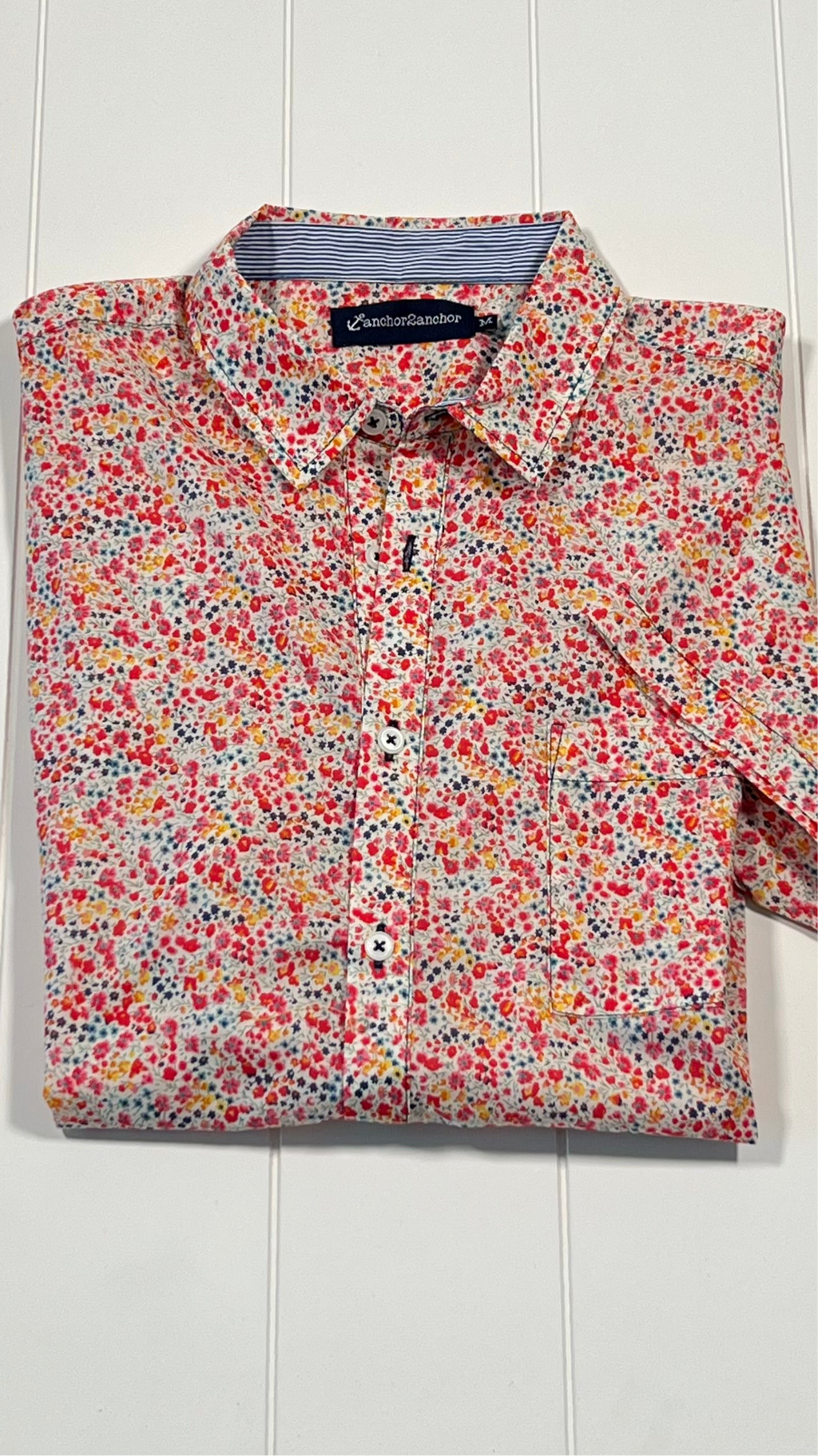 Floral patterned shirt on a white wooden background