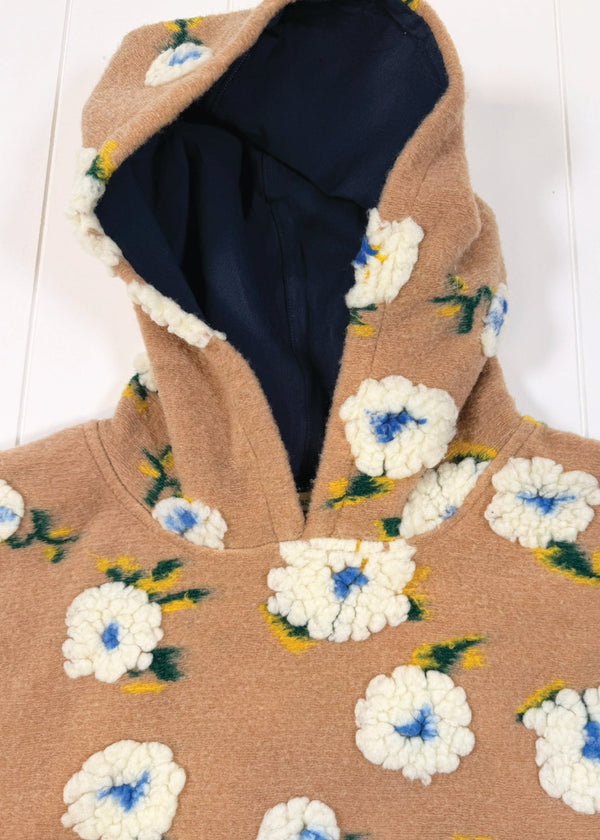 Brown coat with floral patterns on a white background