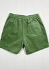 Green shorts on a white wooden background