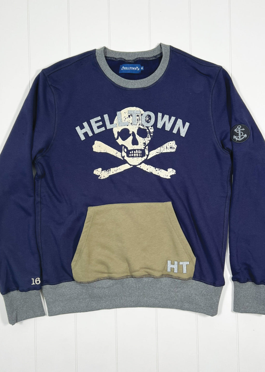 Navy blue sweatshirt with skull design and text on a white background