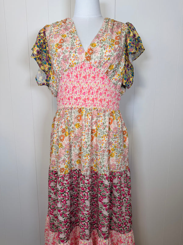 Floral dress on a mannequin against a white wooden panel background