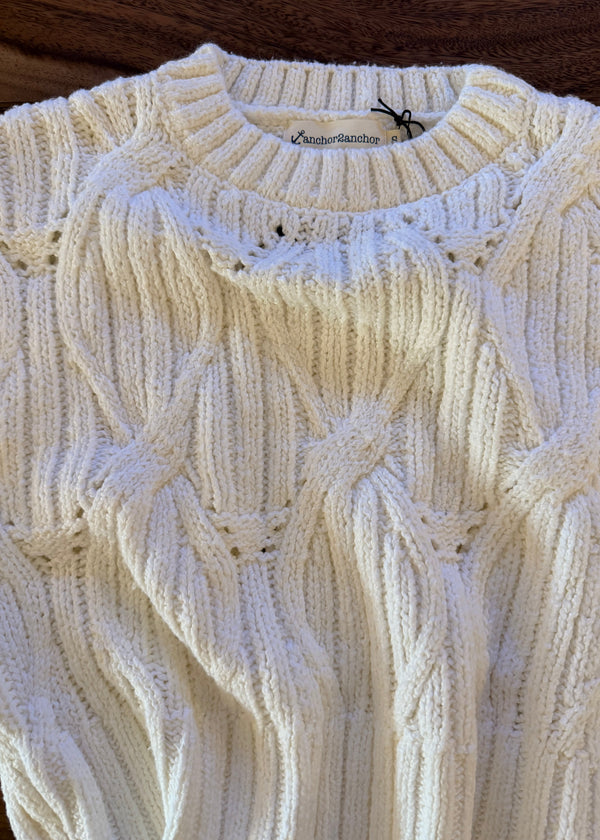 Close-up of a textured white fabric with a subtle pattern
