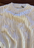 Close-up of a textured white fabric with a subtle pattern