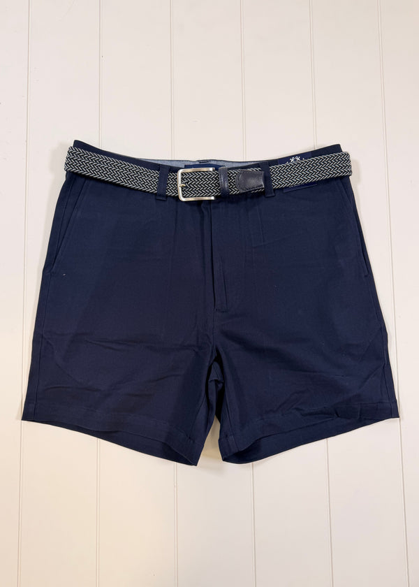 Navy shorts with a belt on a light wooden background