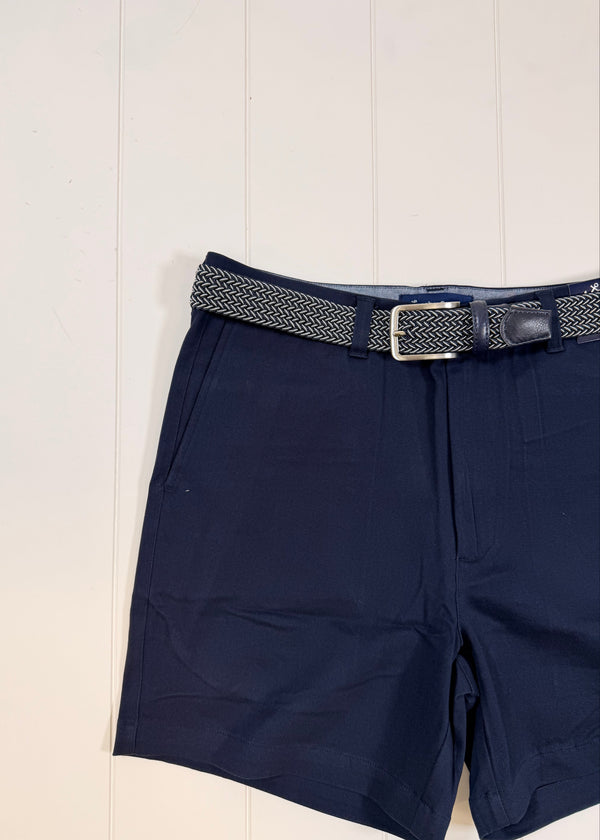 Navy blue pants with a belt on a light wooden floor