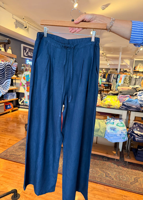 Blue pants on a hanger in a store setting