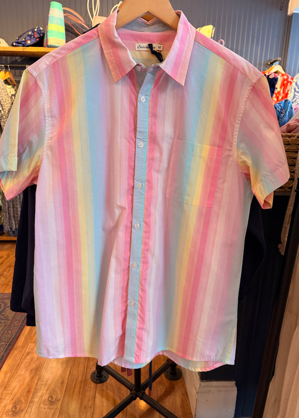 Pastel striped shirt on a hanger in a store setting