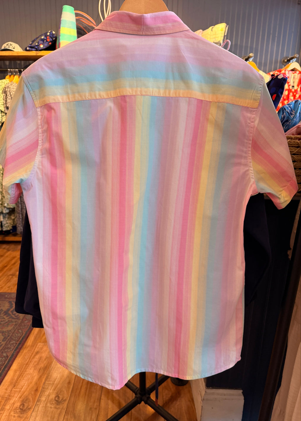 Pastel striped shirt on a mannequin in a store setting