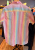 Pastel striped shirt on a mannequin in a store setting