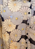 Close-up of a floral patterned fabric with black buttons.