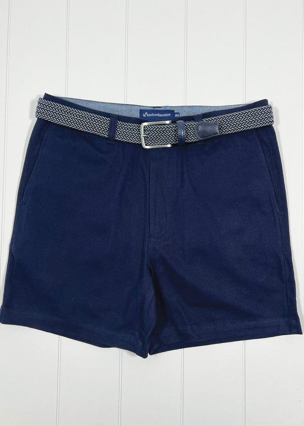 Navy shorts with a belt on a white wooden background