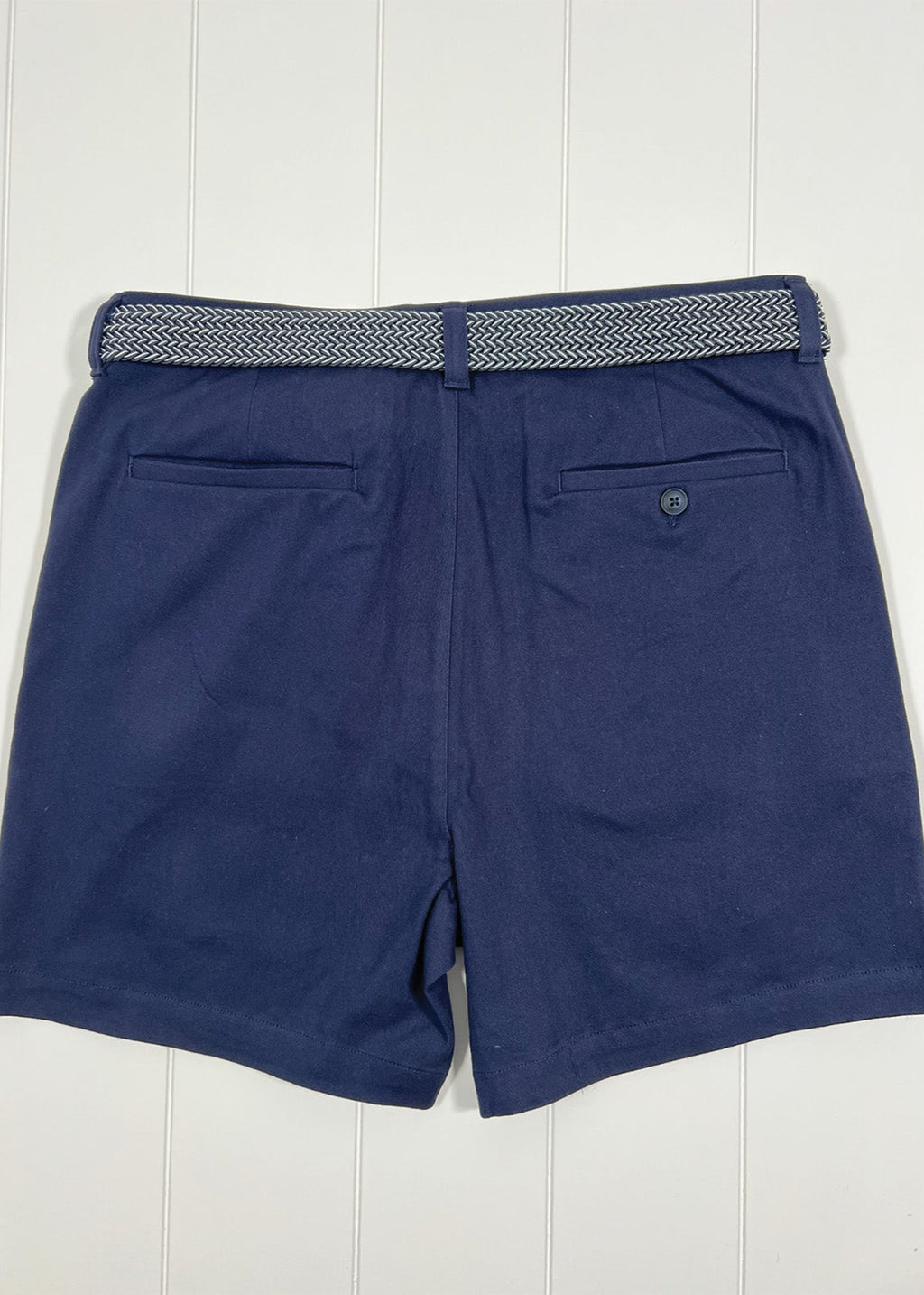 Navy shorts with a patterned belt on a white background