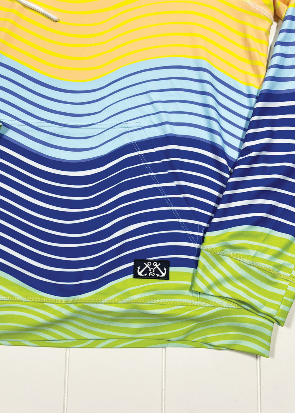 Colorful striped shirt with a logo on a white background