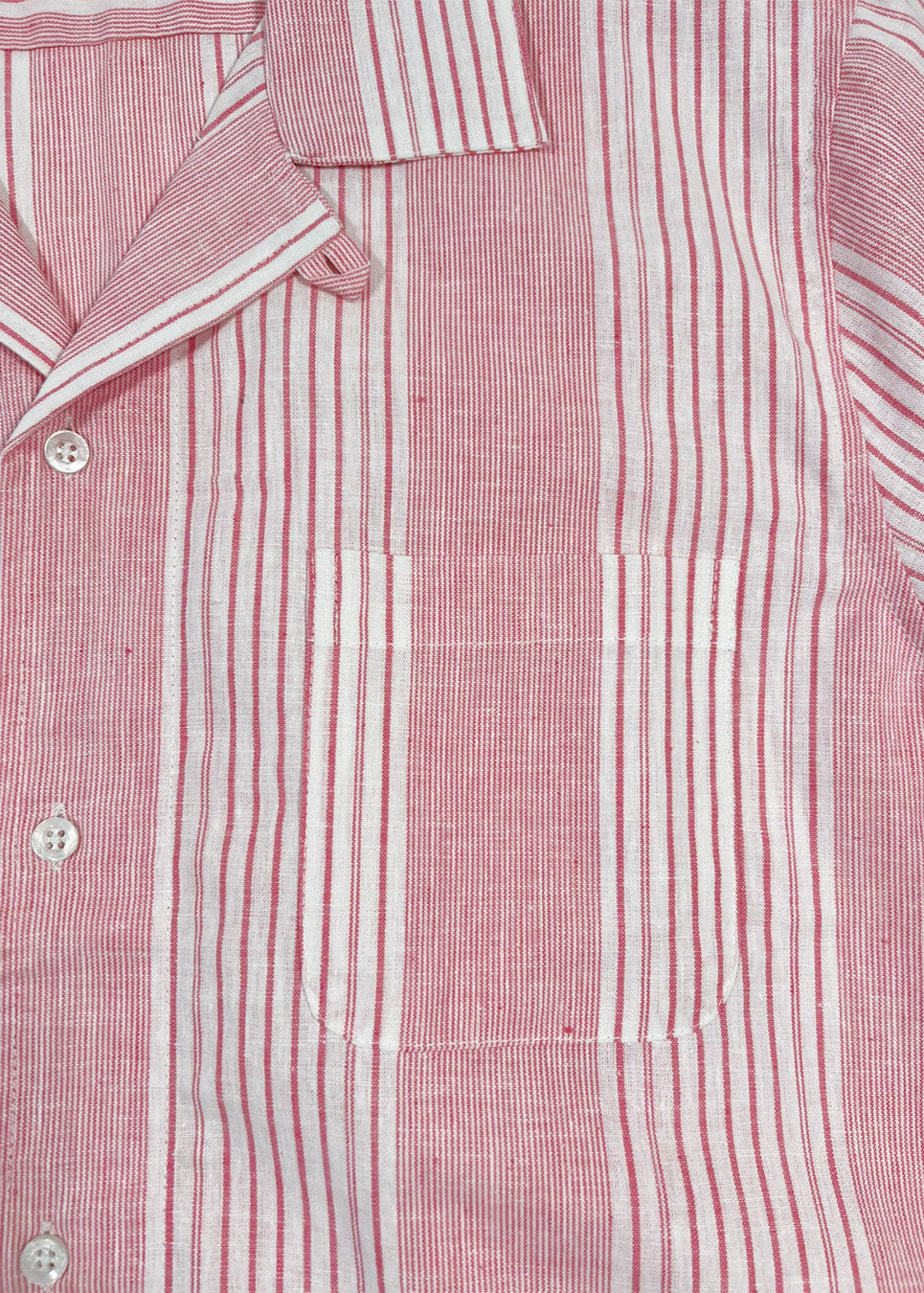 Close-up of a red and white striped shirt with buttons.