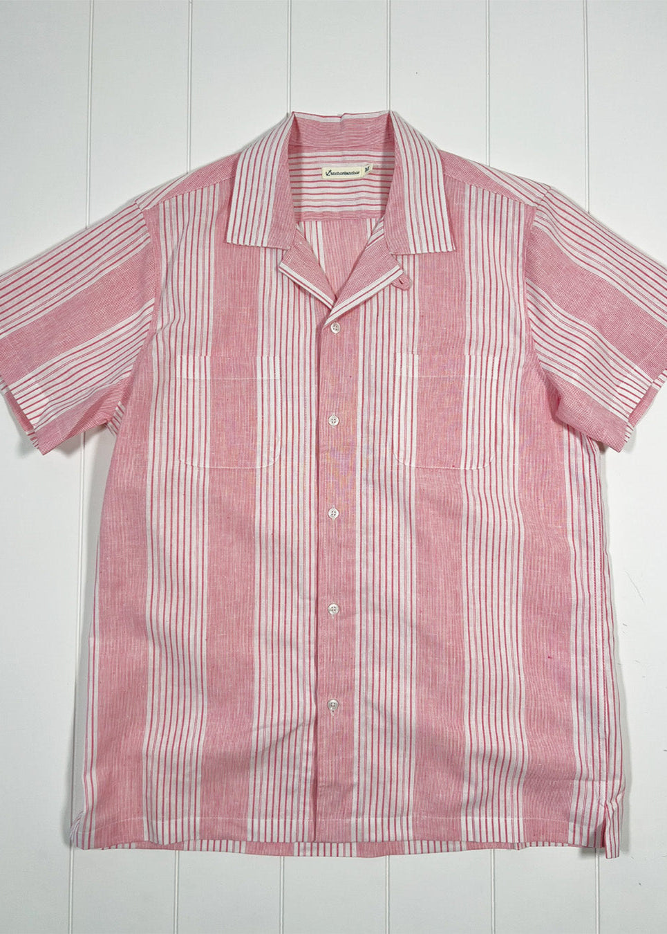 Red and white striped shirt on a white wooden background