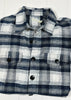 Plaid shirt with black buttons on a white background