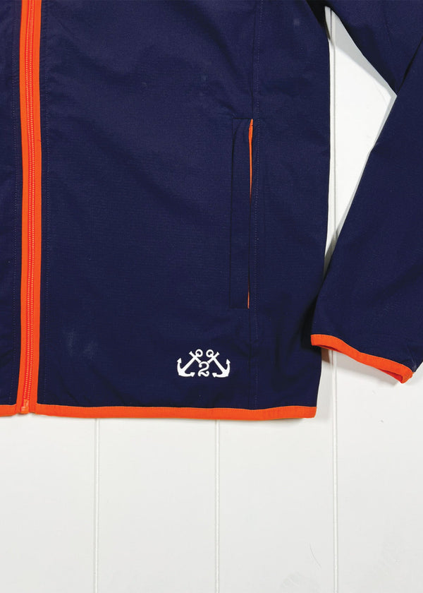 Navy jacket with orange trim and a logo on a white background