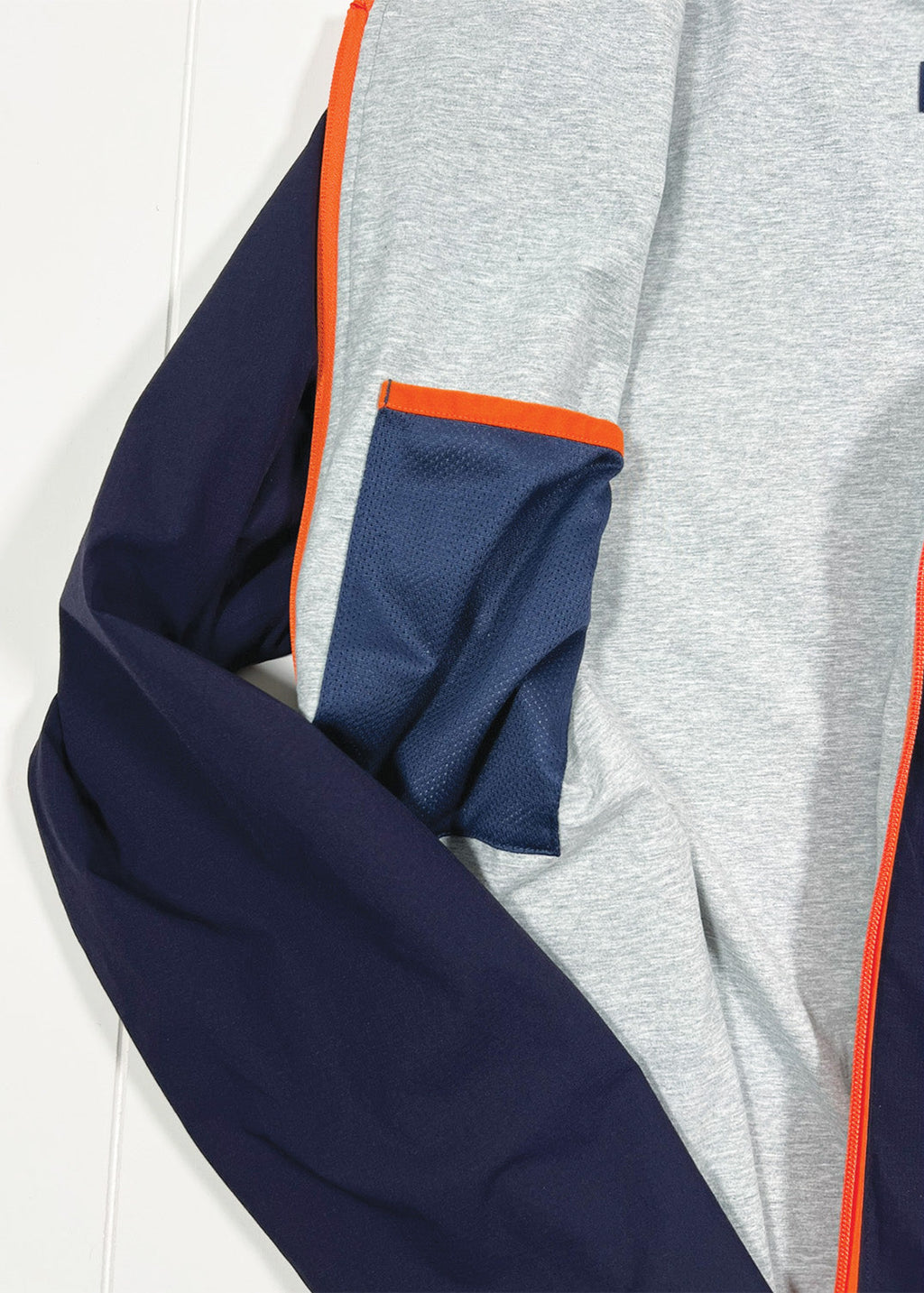 Gray and navy jacket with orange trim on a white background