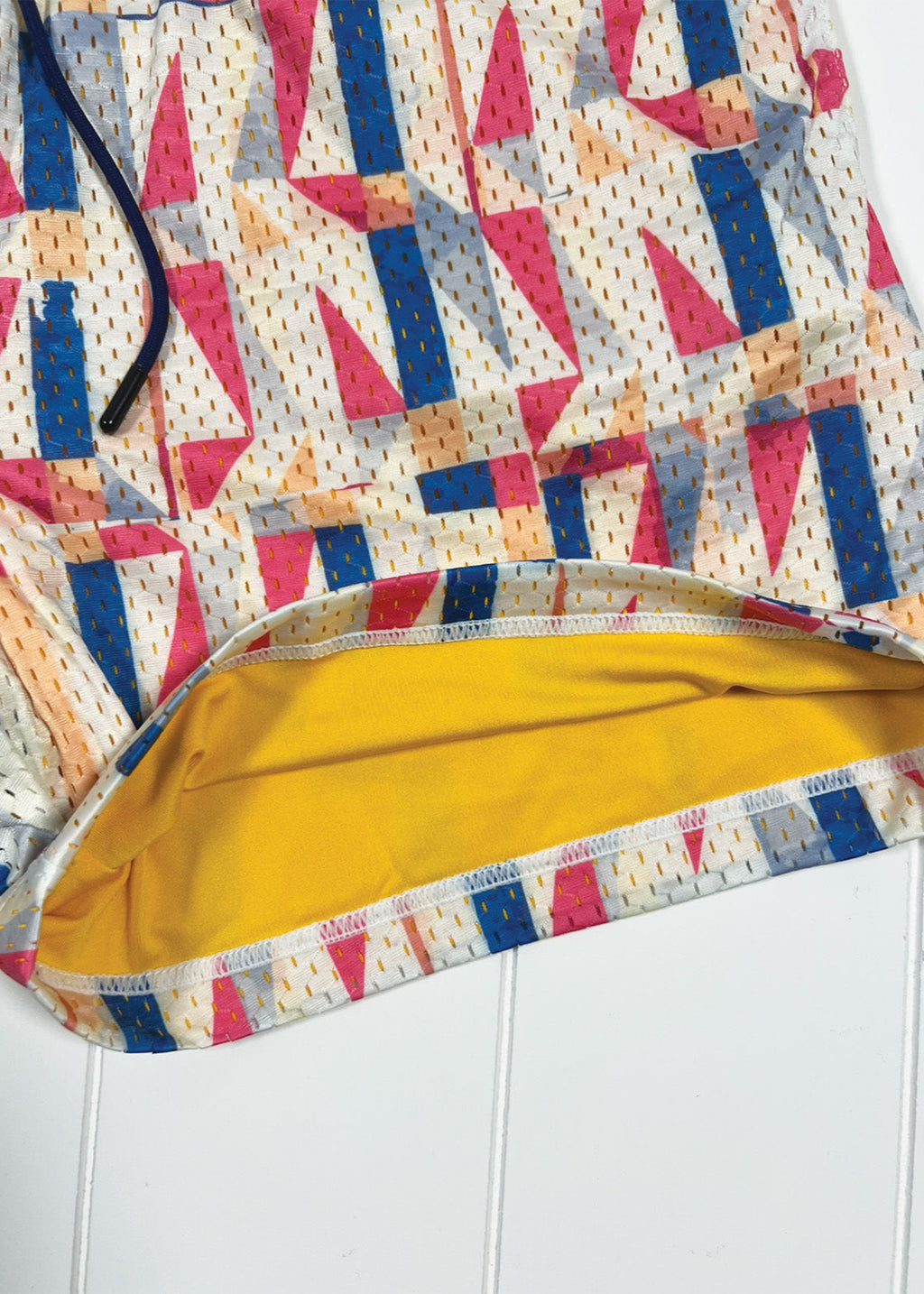 Colorful geometric patterned fabric with a yellow interior on a white background