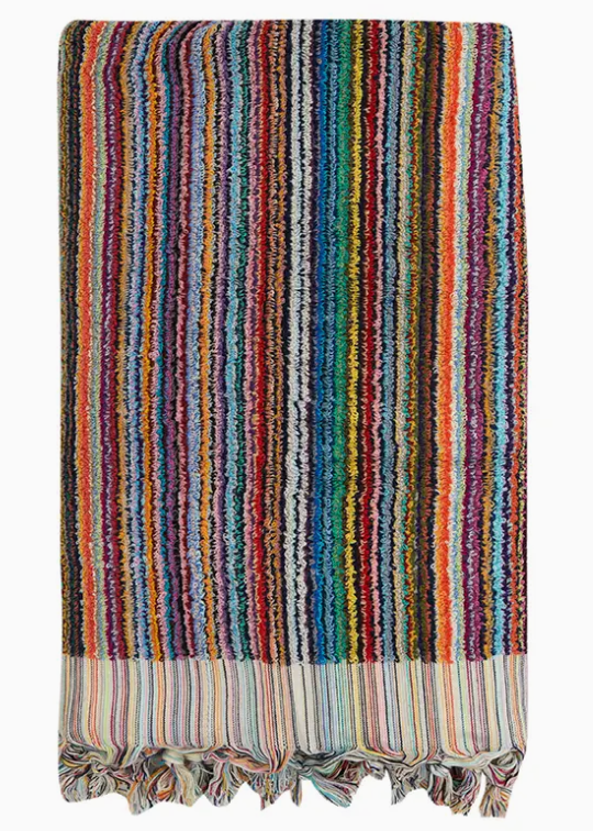 Multicolored striped towel with frayed edges on a white background
