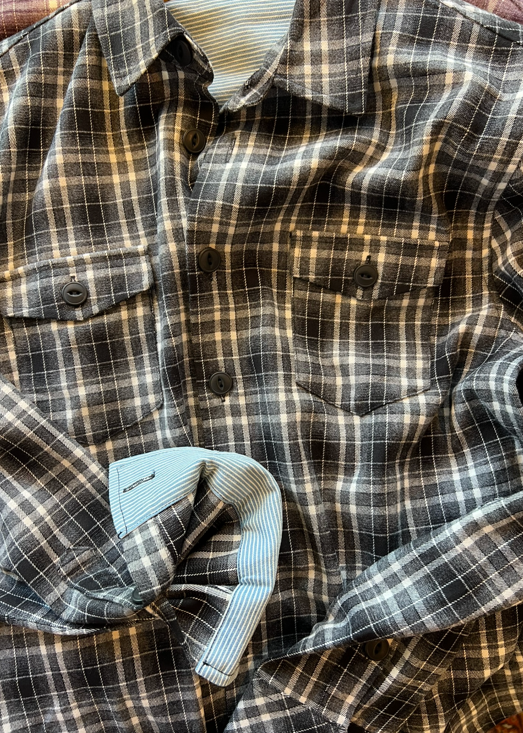 Plaid shirt with a focus on the fabric pattern and texture.