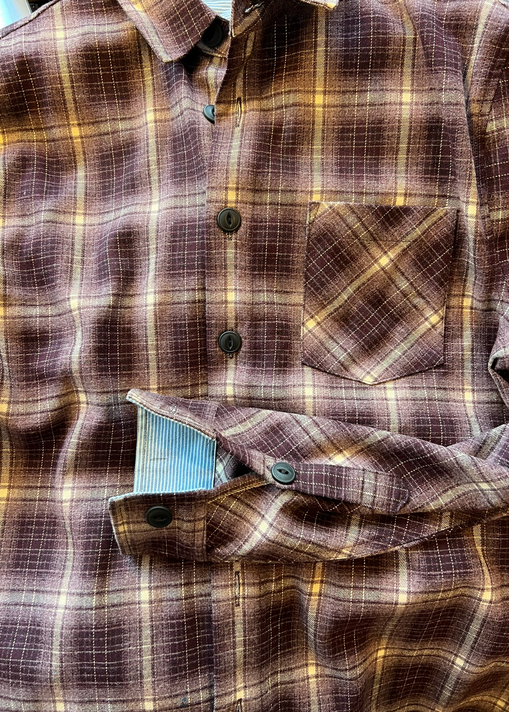 Brown and yellow plaid shirt with a button-up front.