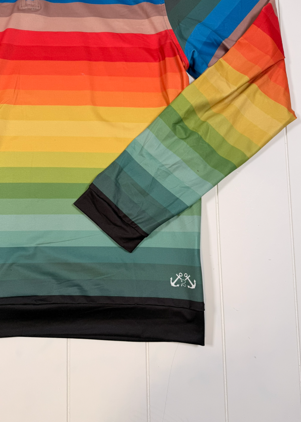 Colorful striped fabric with a brand logo on a white background