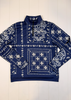 Navy blue sweatshirt with white bandana pattern on a white wooden background