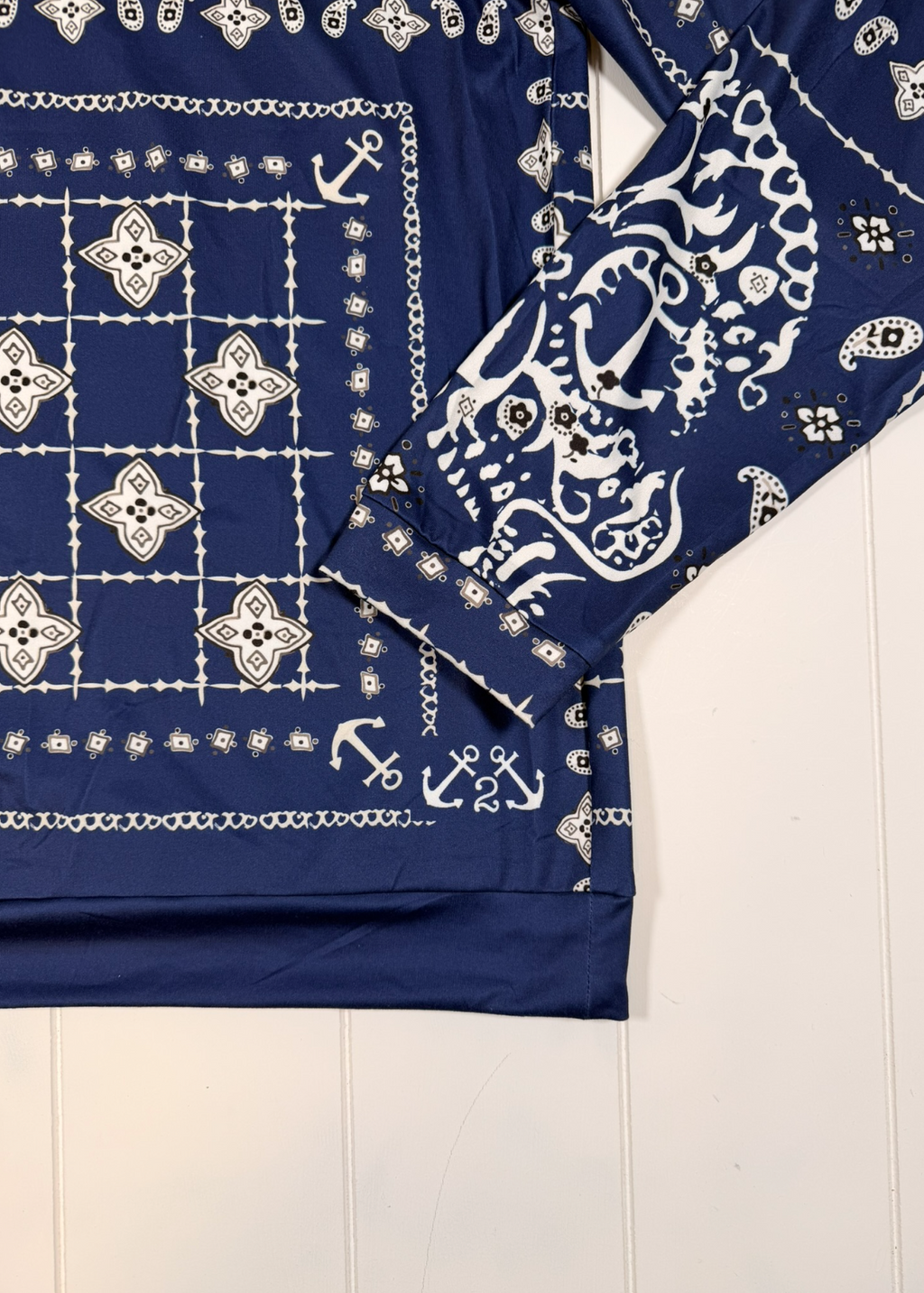 Navy blue bandana with white patterns on a light wooden surface